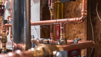 Copper press piping, isolation valves and a yellow gas line plumbed in a mechanical room by Black Forest Plumbing