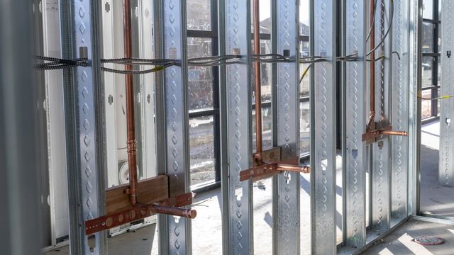 Copper water lines stubbed out through steel studs on a commercial rough-in by Black Forest Plumbing